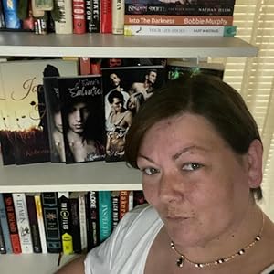 Photo of the author Rebeccah Joyce standing in front of a bookshelf